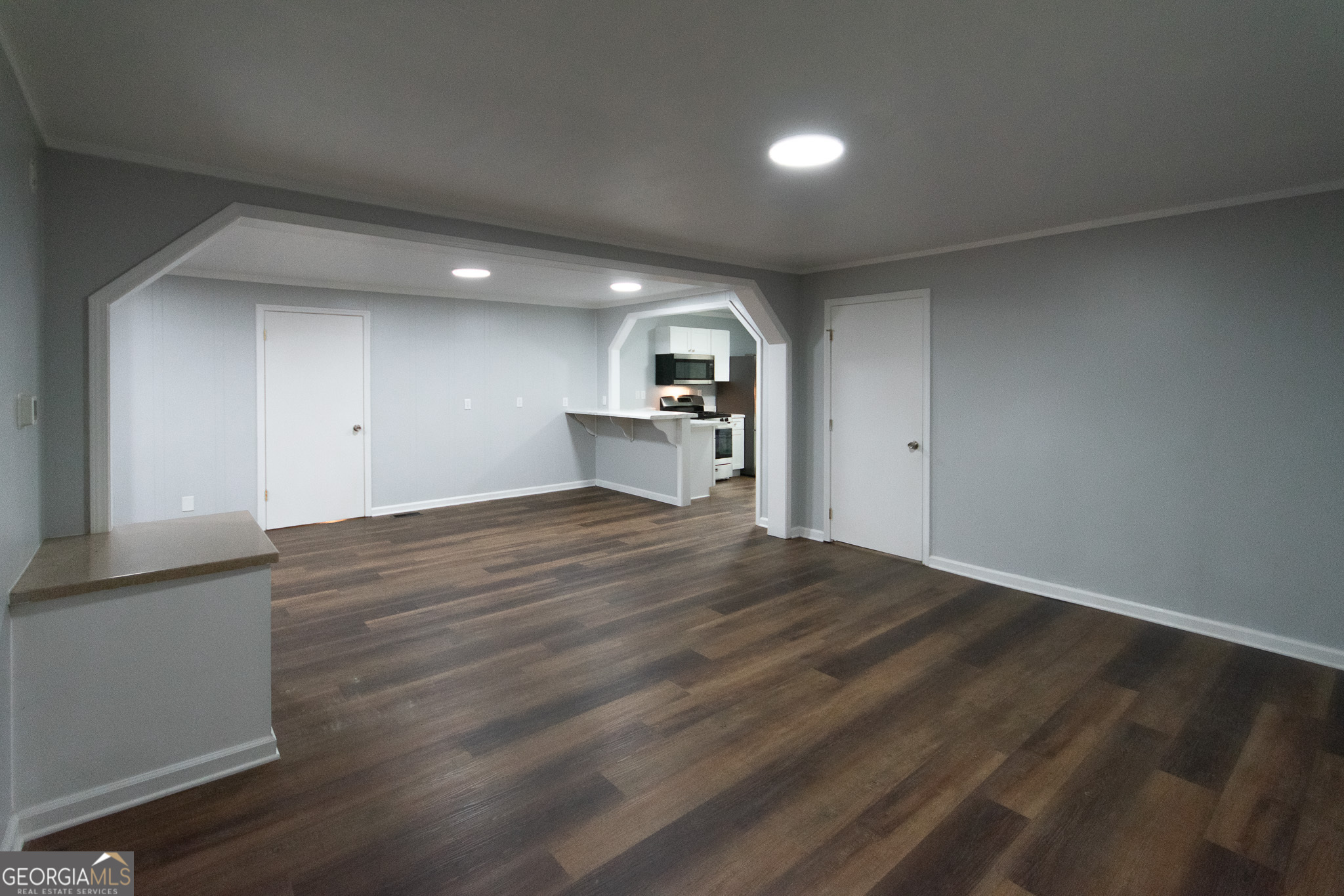 a view of a kitchen with a sink and a refrigerator