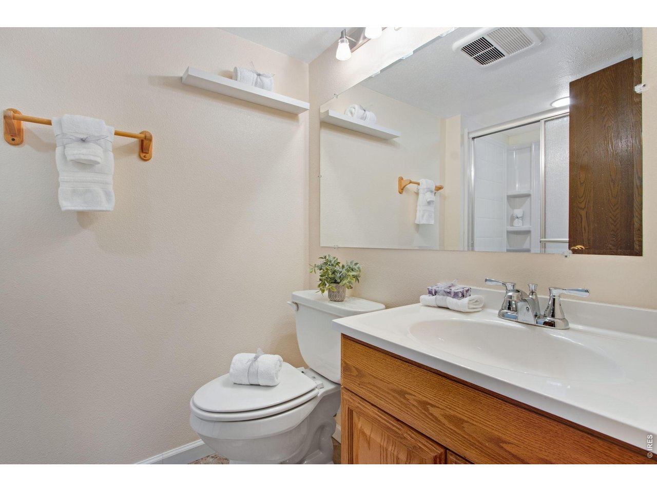 300 Ruth Street Fort Collins, CO 80525 - Photo 35 of 37 a bathroom with a sink vanity mirror and toilet