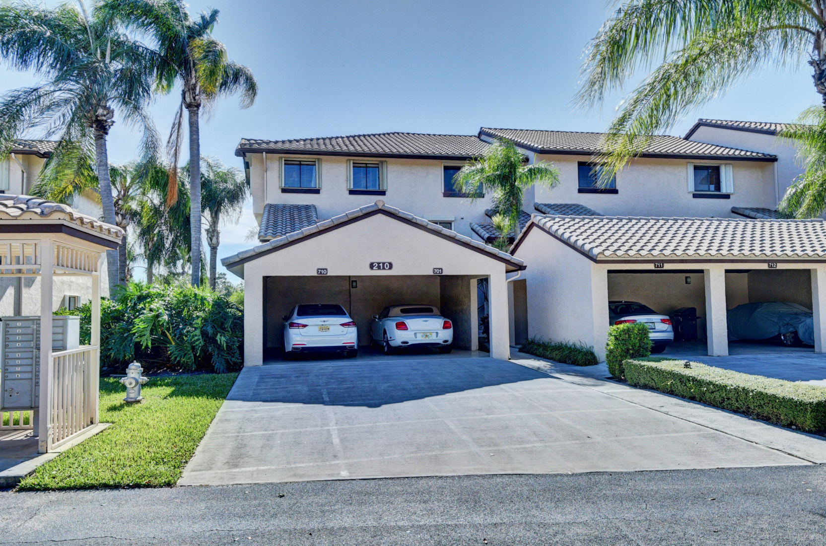 210 Captains Walk, Unit 710 Delray Beach, FL 33483 - Photo 1 of 49 a front view of a house with a yard and garage