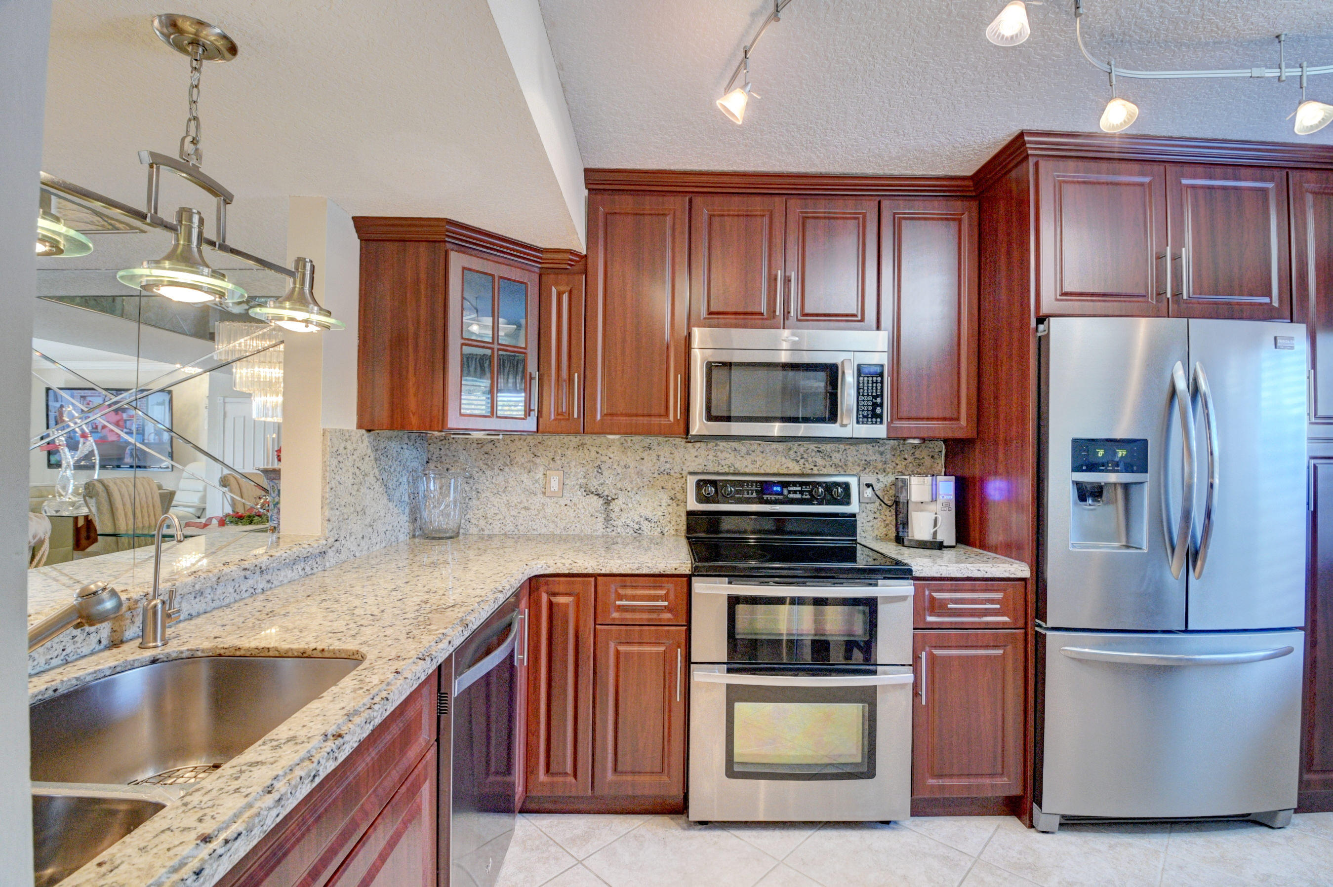 210 Captains Walk, Unit 710 Delray Beach, FL 33483 - Photo 11 of 49 a kitchen with a refrigerator sink and microwave