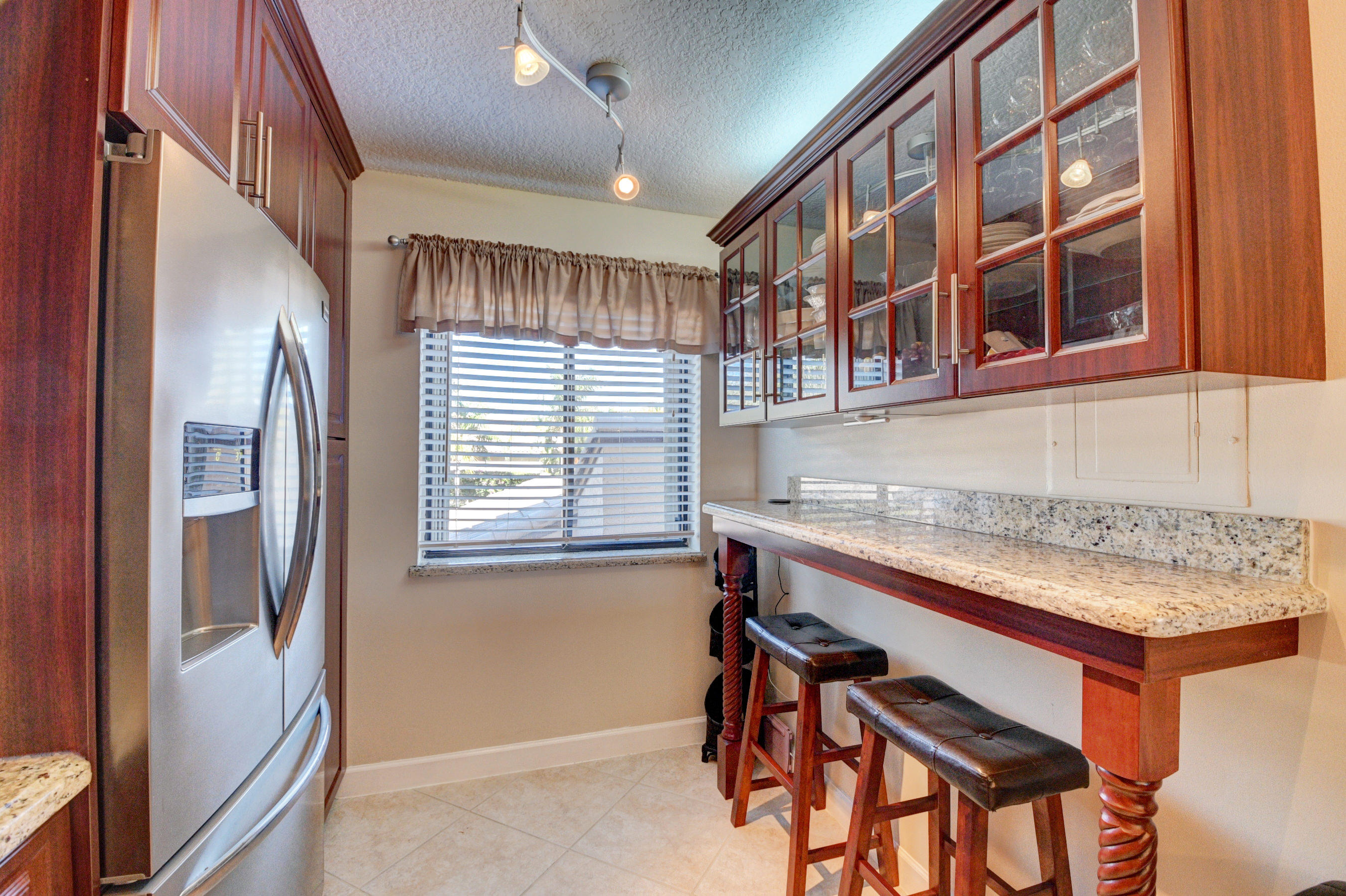 210 Captains Walk, Unit 710 Delray Beach, FL 33483 - Photo 13 of 49 a hallway with a large window and chandelier