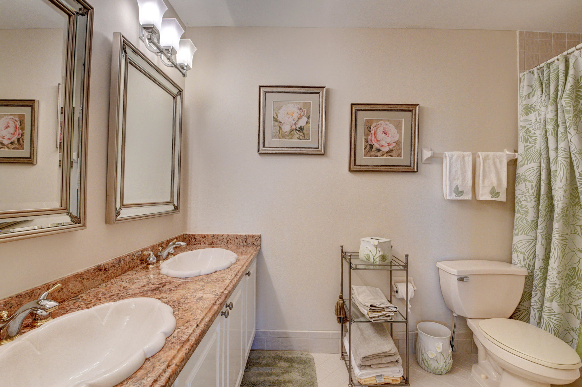 210 Captains Walk, Unit 710 Delray Beach, FL 33483 - Photo 19 of 49 a bathroom with a granite countertop toilet sink and mirror