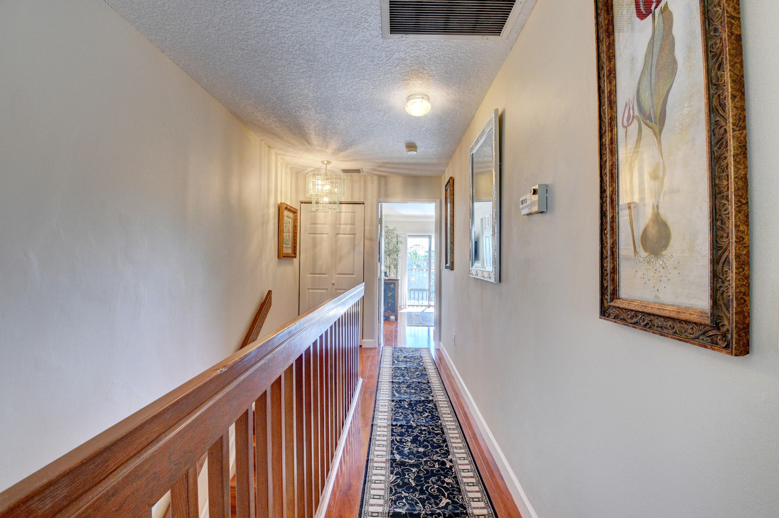 210 Captains Walk, Unit 710 Delray Beach, FL 33483 - Photo 20 of 49 a view of a hallway with wooden floor