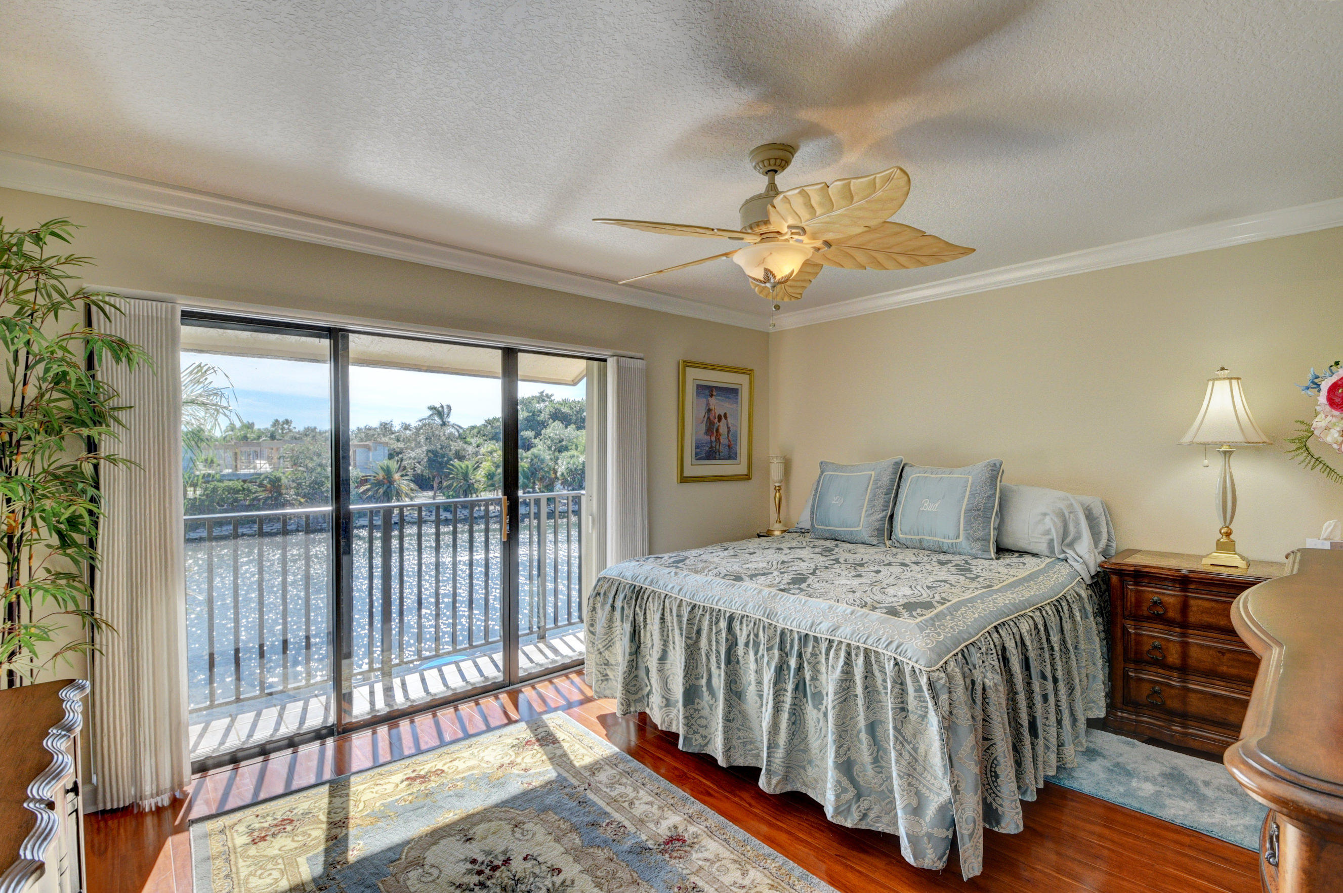 210 Captains Walk, Unit 710 Delray Beach, FL 33483 - Photo 21 of 49 a bedroom with a bed and a chandelier