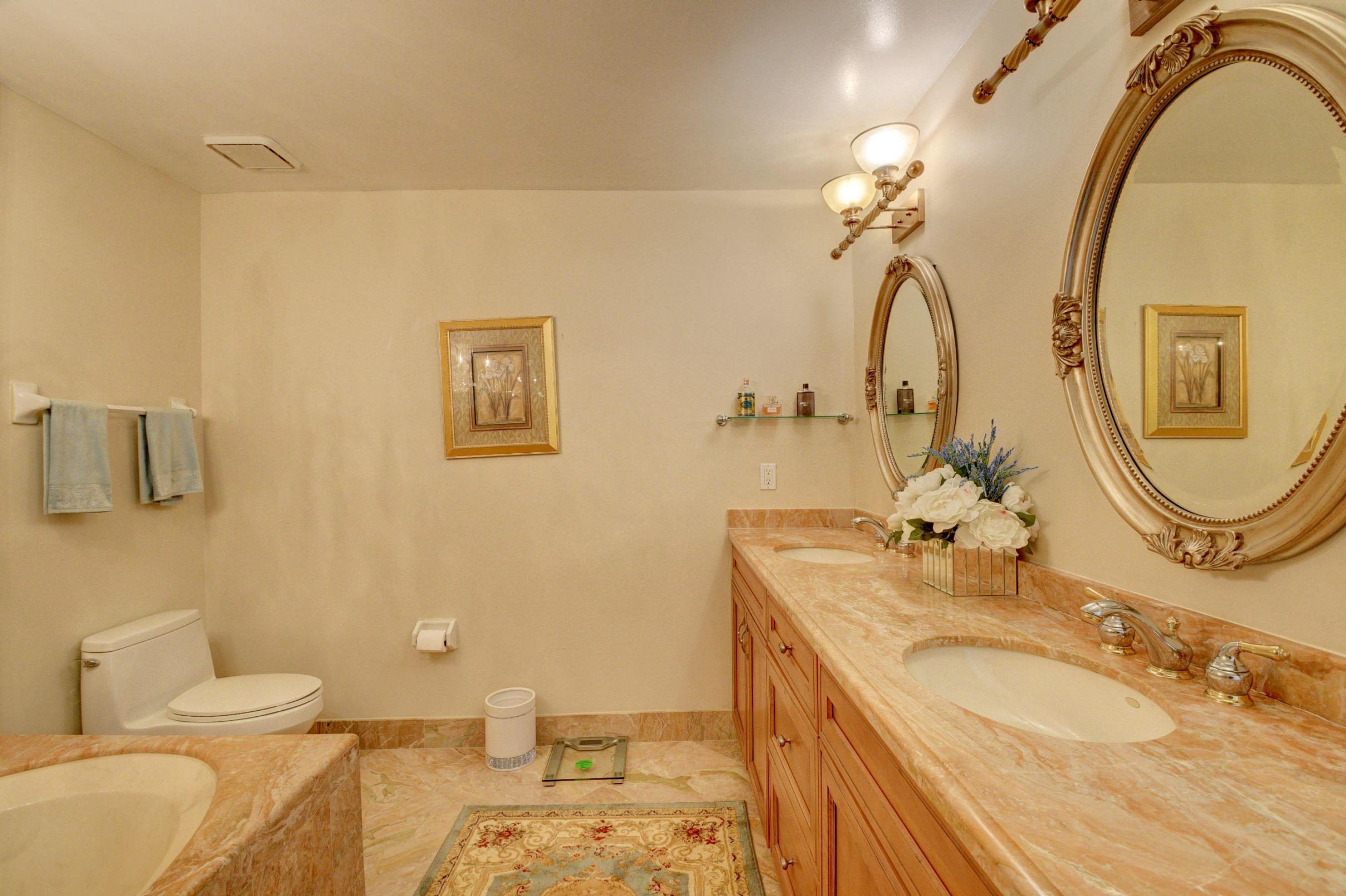 210 Captains Walk, Unit 710 Delray Beach, FL 33483 - Photo 24 of 49 a bathroom with a granite countertop sink and a mirror