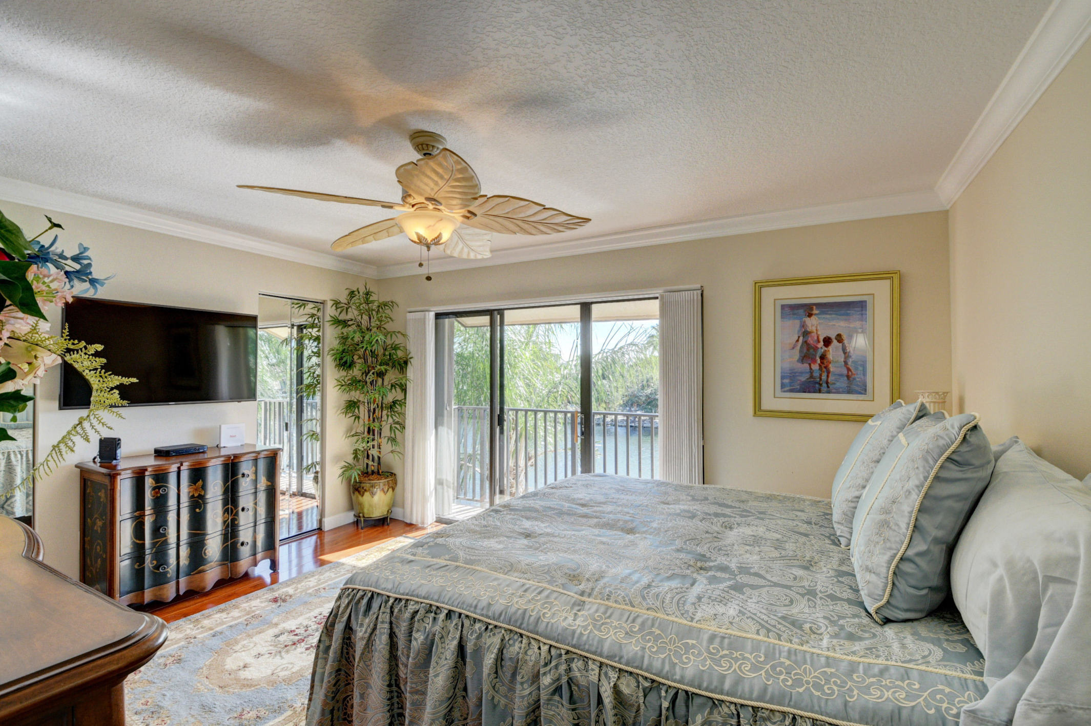 210 Captains Walk, Unit 710 Delray Beach, FL 33483 - Photo 25 of 49 a bedroom with a bed a flat screen tv and a window