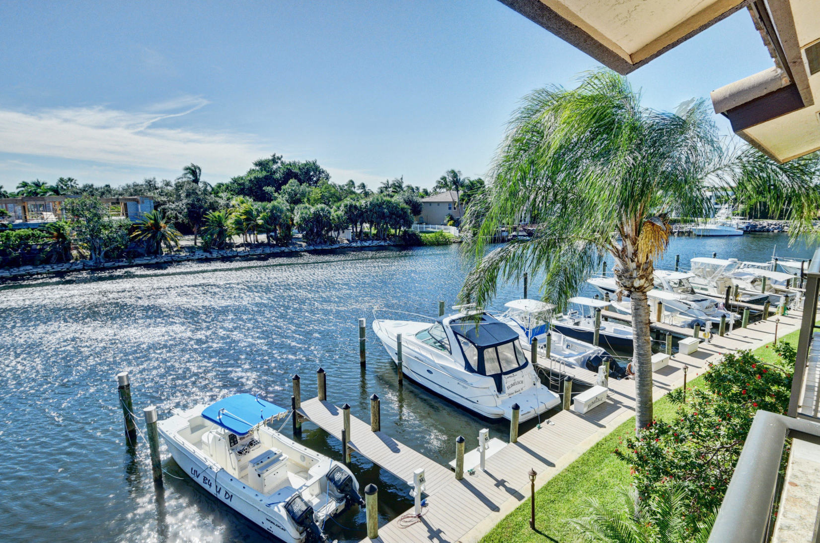 210 Captains Walk, Unit 710 Delray Beach, FL 33483 - Photo 26 of 49 a view of a patio with couches chairs and a table and chairs with wooden fence
