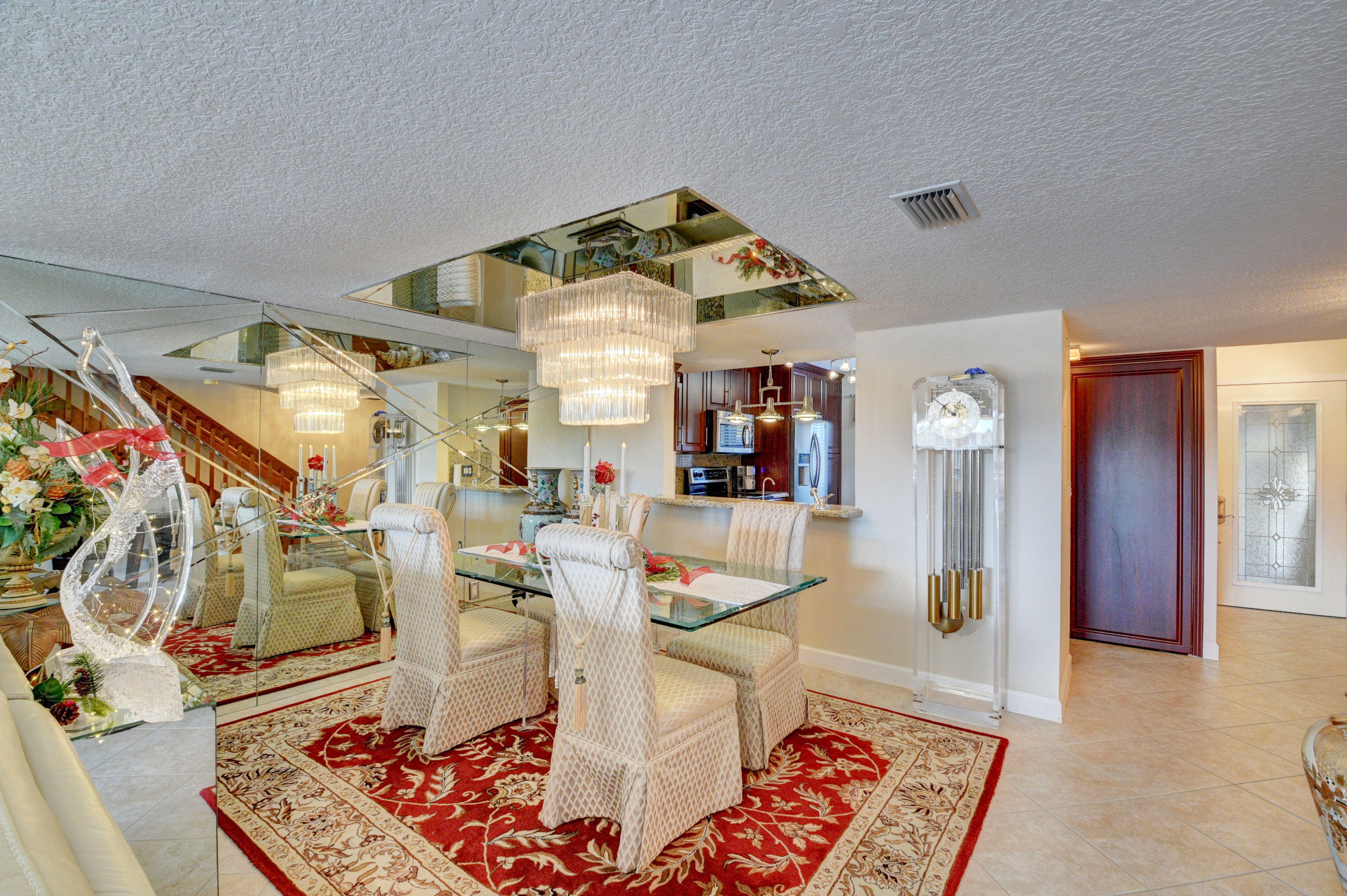 210 Captains Walk, Unit 710 Delray Beach, FL 33483 - Photo 5 of 49 a living room with furniture and a rug