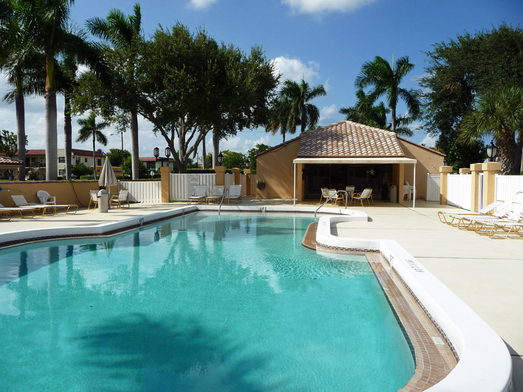 210 Captains Walk, Unit 710 Delray Beach, FL 33483 - Photo 41 of 49 a view of a house with swimming pool and sitting area