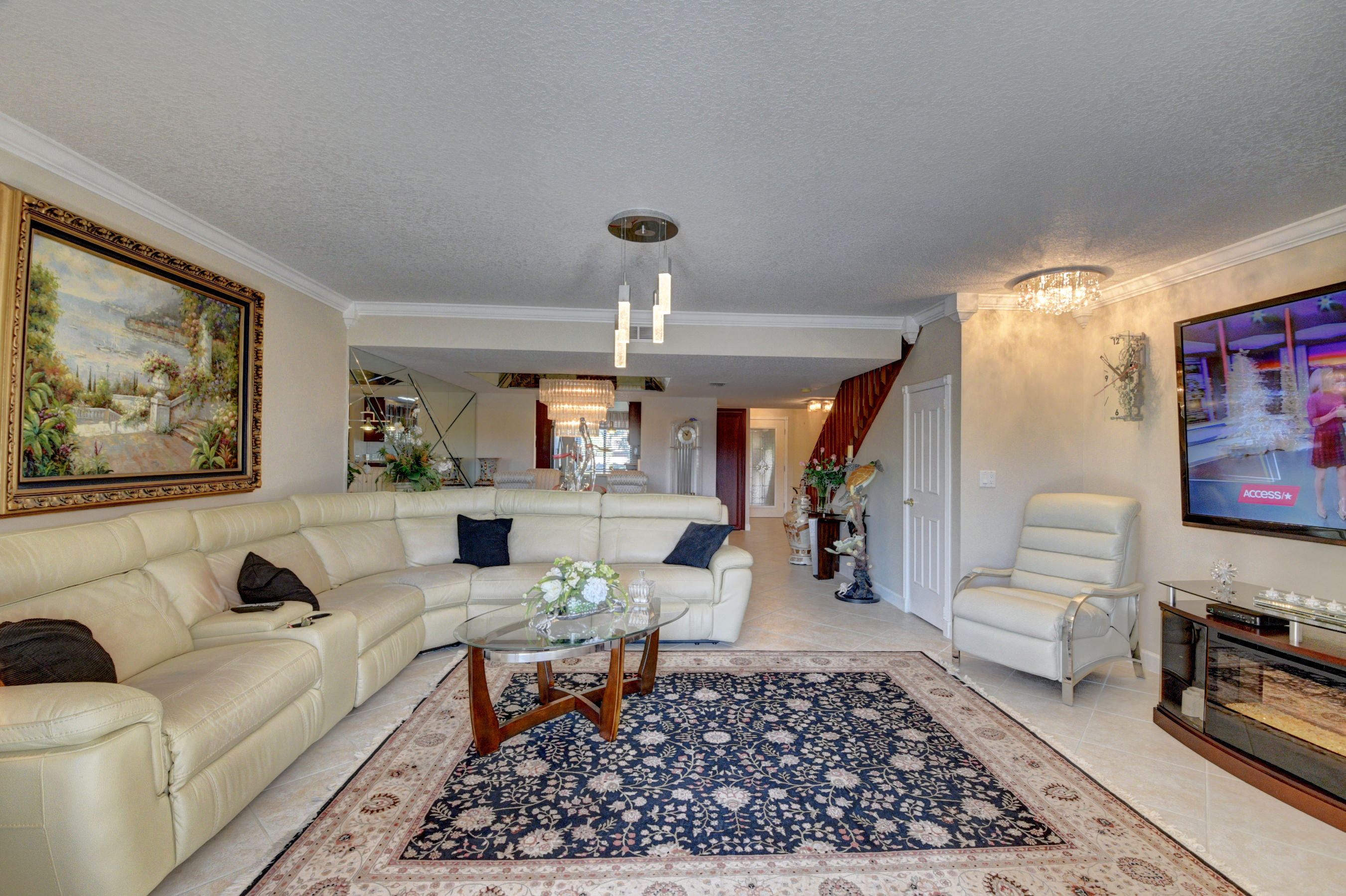 210 Captains Walk, Unit 710 Delray Beach, FL 33483 - Photo 9 of 49 a living room with furniture a rug and a flat screen tv