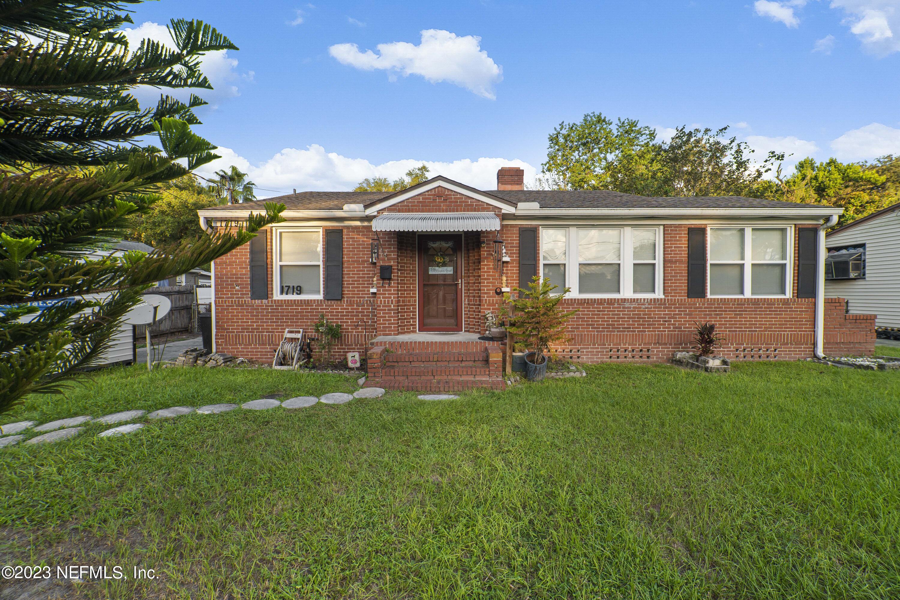 1719 Mayfair Road Jacksonville, FL 32207 - Photo 1 of 14 a front view of a house with a garden