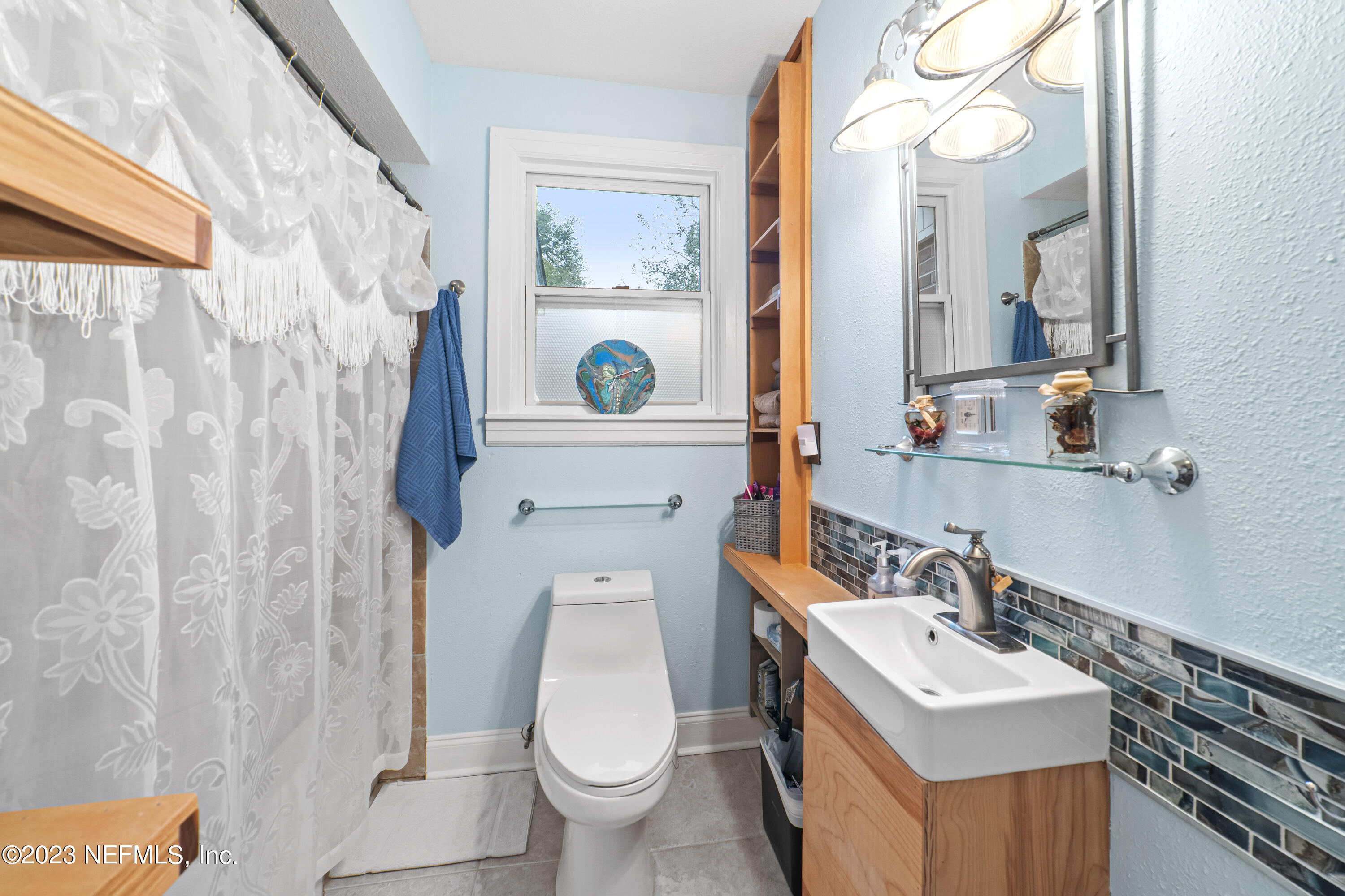 1719 Mayfair Road Jacksonville, FL 32207 - Photo 11 of 14 a bathroom with a sink toilet and mirror