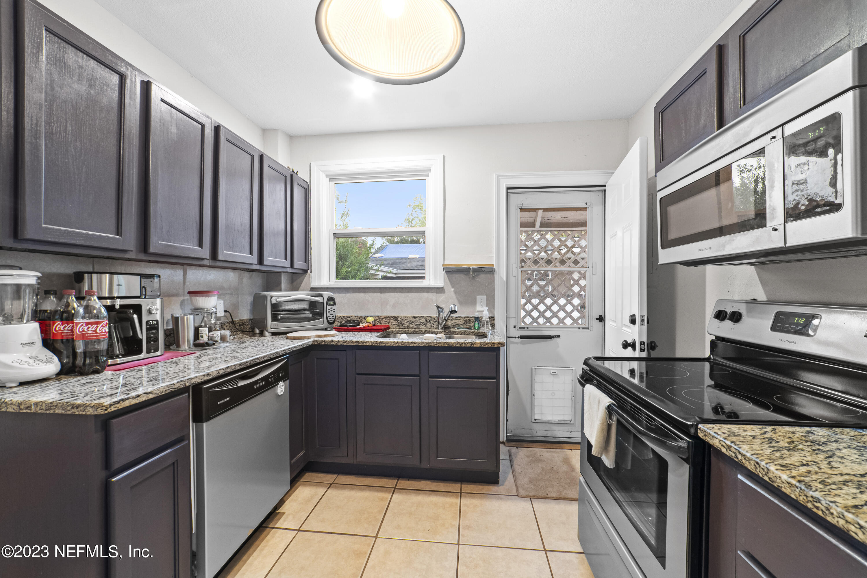 1719 Mayfair Road Jacksonville, FL 32207 - Photo 8 of 14 a kitchen with stainless steel appliances granite countertop a stove sink and cabinets