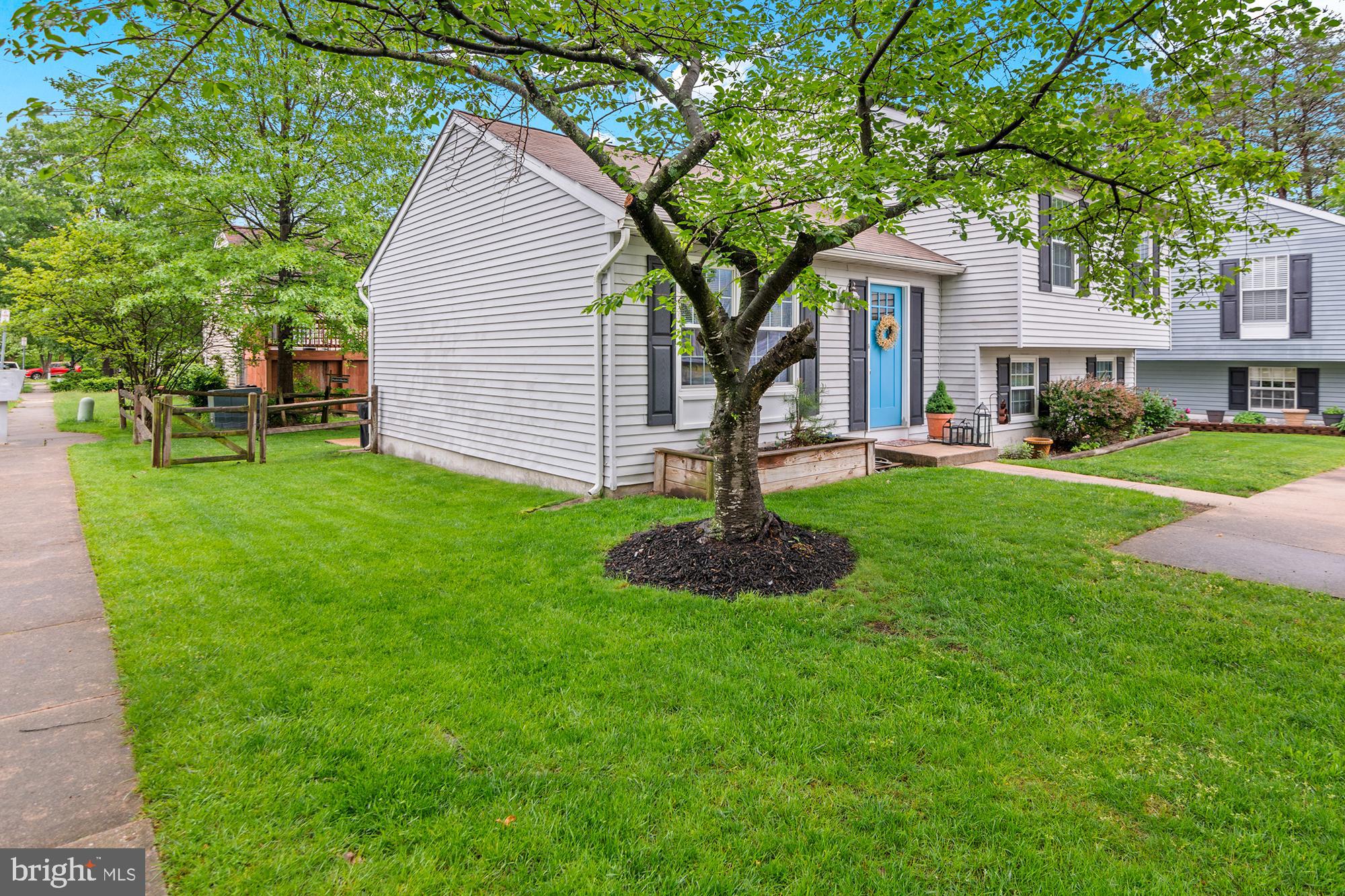 5117 Clifford Road Perry Hall, MD 21128 - Photo 1 of 36 a front view of a house with a garden and trees