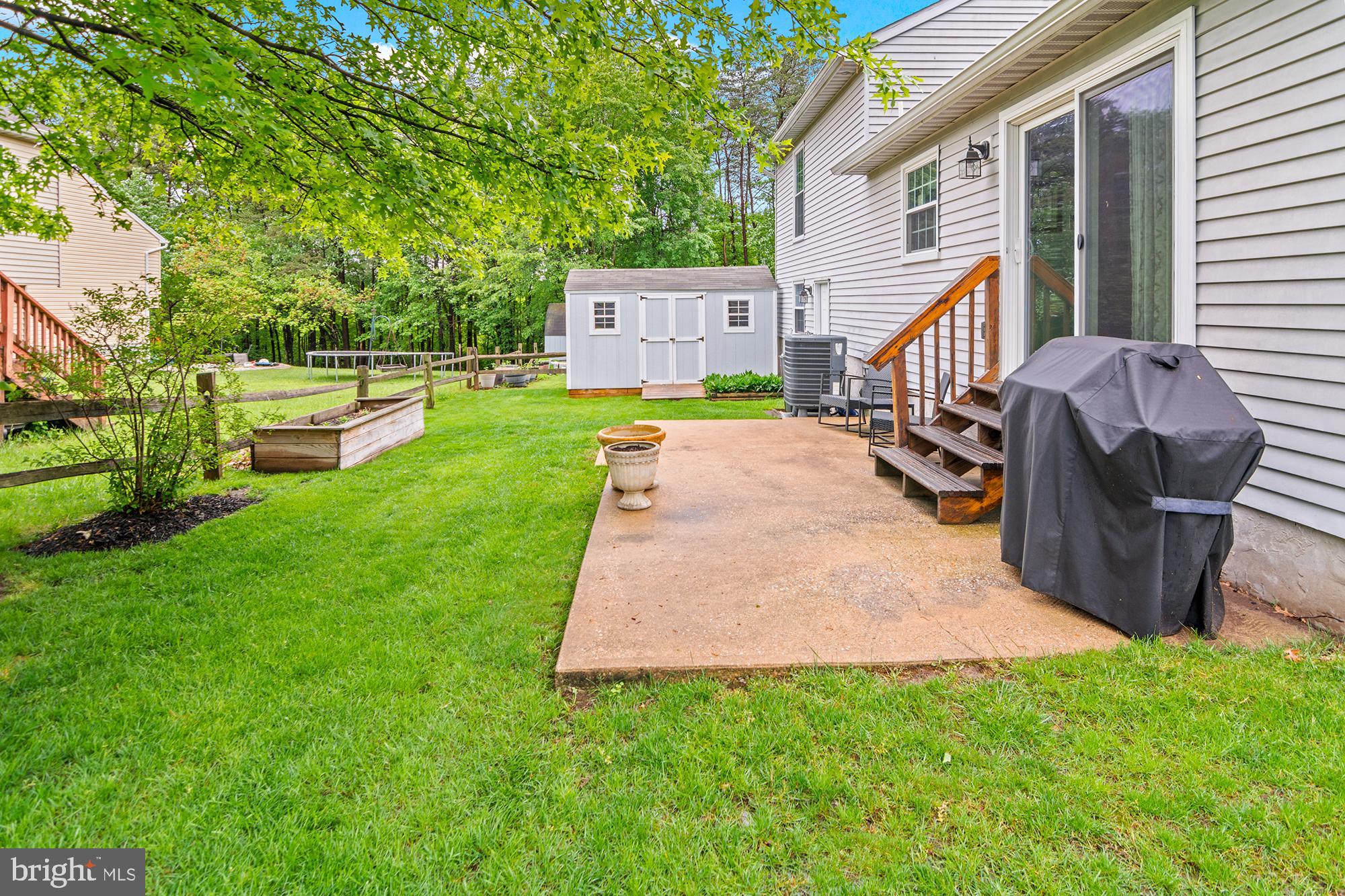 5117 Clifford Road Perry Hall, MD 21128 - Photo 32 of 36 a view of a patio with table and chairs potted plants and a large tree