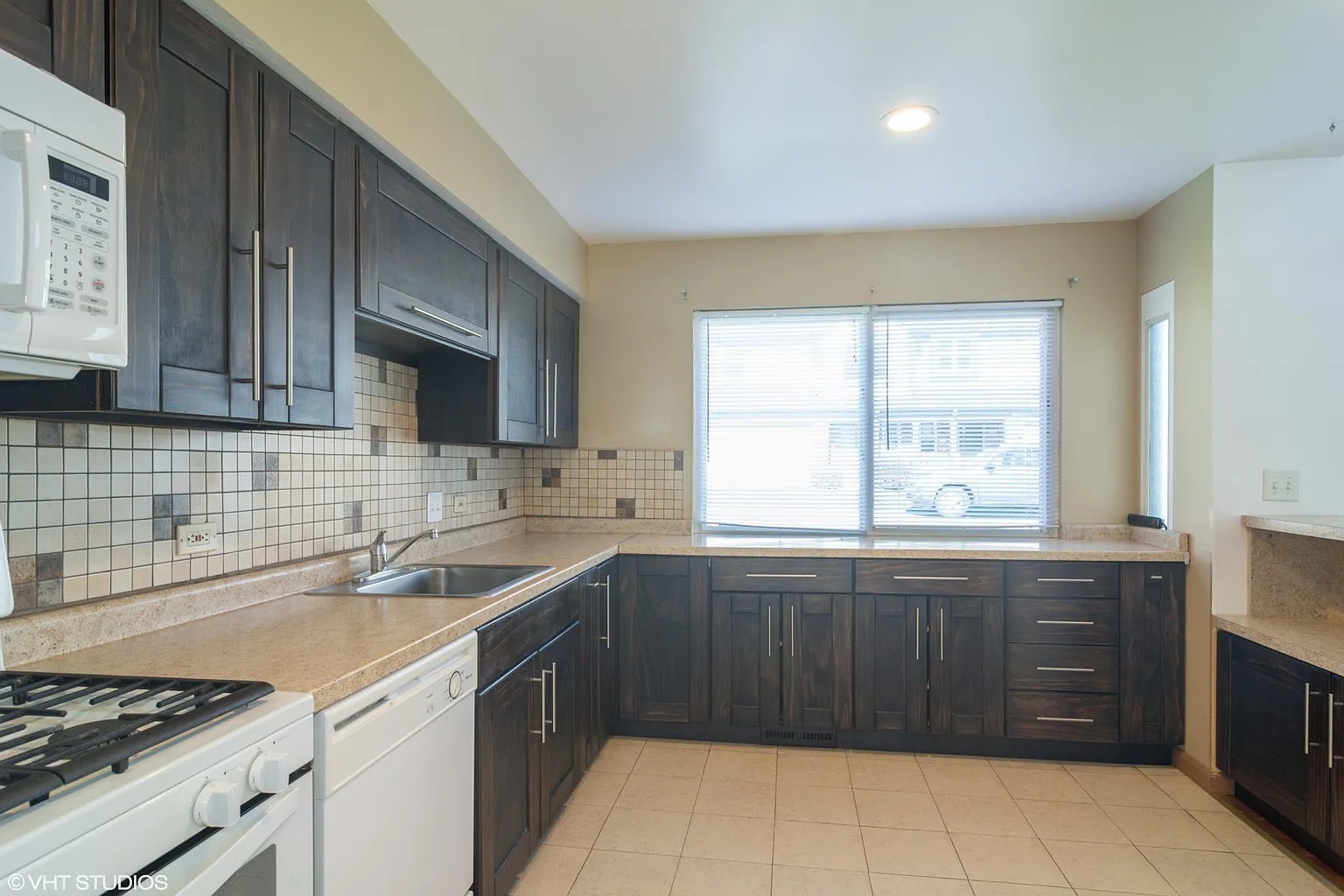760 East Whispering Oaks Drive, Unit 4A Palatine, IL 60074 - Photo 2 of 10 a kitchen with a sink a stove and cabinets