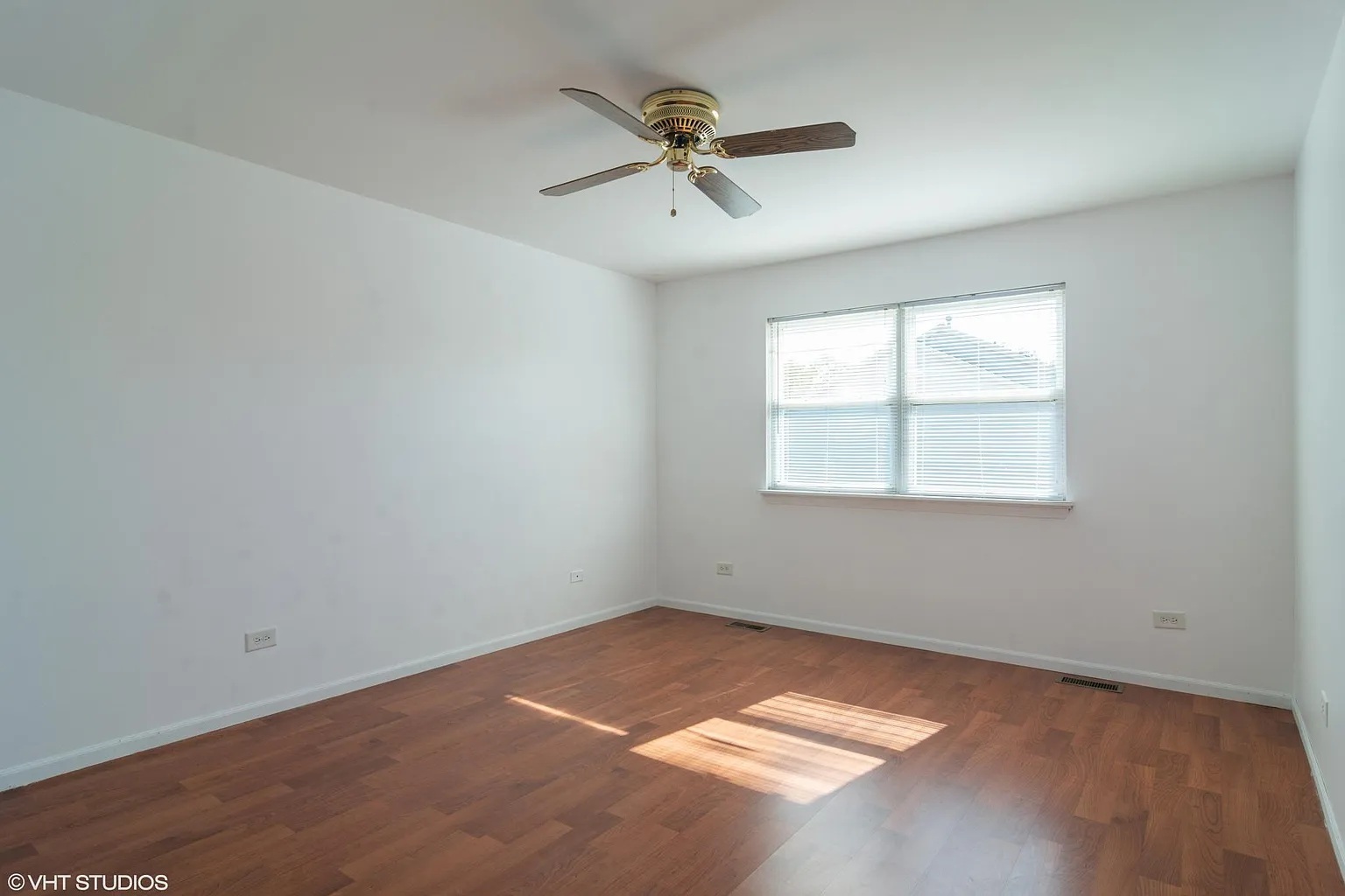 760 East Whispering Oaks Drive, Unit 4A Palatine, IL 60074 - Photo 7 of 10 an empty room with a window and a ceiling fan