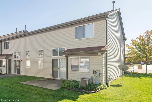 a front view of a house with yard and glass windows