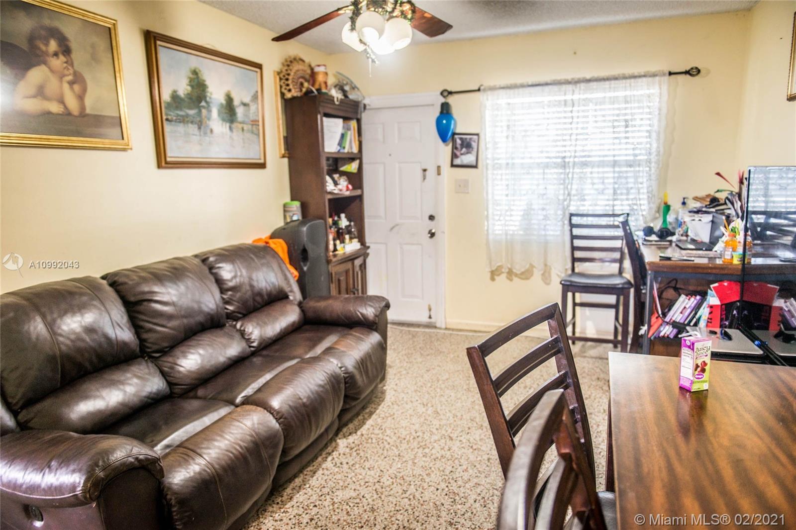 105 Northeast 2nd Road Homestead, FL 33030 - Photo 13 of 26 a living room with furniture and a flat screen tv