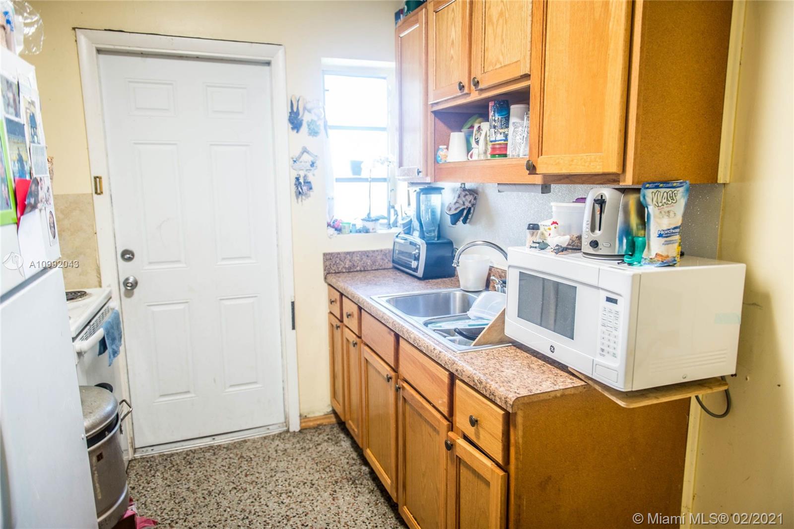 105 Northeast 2nd Road Homestead, FL 33030 - Photo 14 of 26 a kitchen with stainless steel appliances granite countertop a sink stove and refrigerator