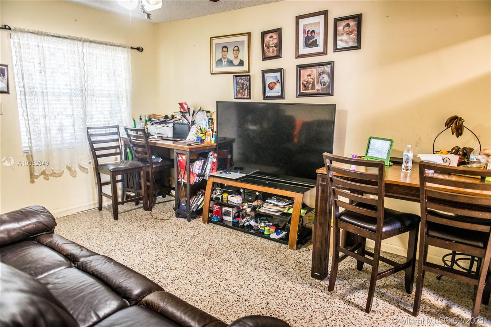 105 Northeast 2nd Road Homestead, FL 33030 - Photo 16 of 26 a living room with furniture a flat screen tv and a window