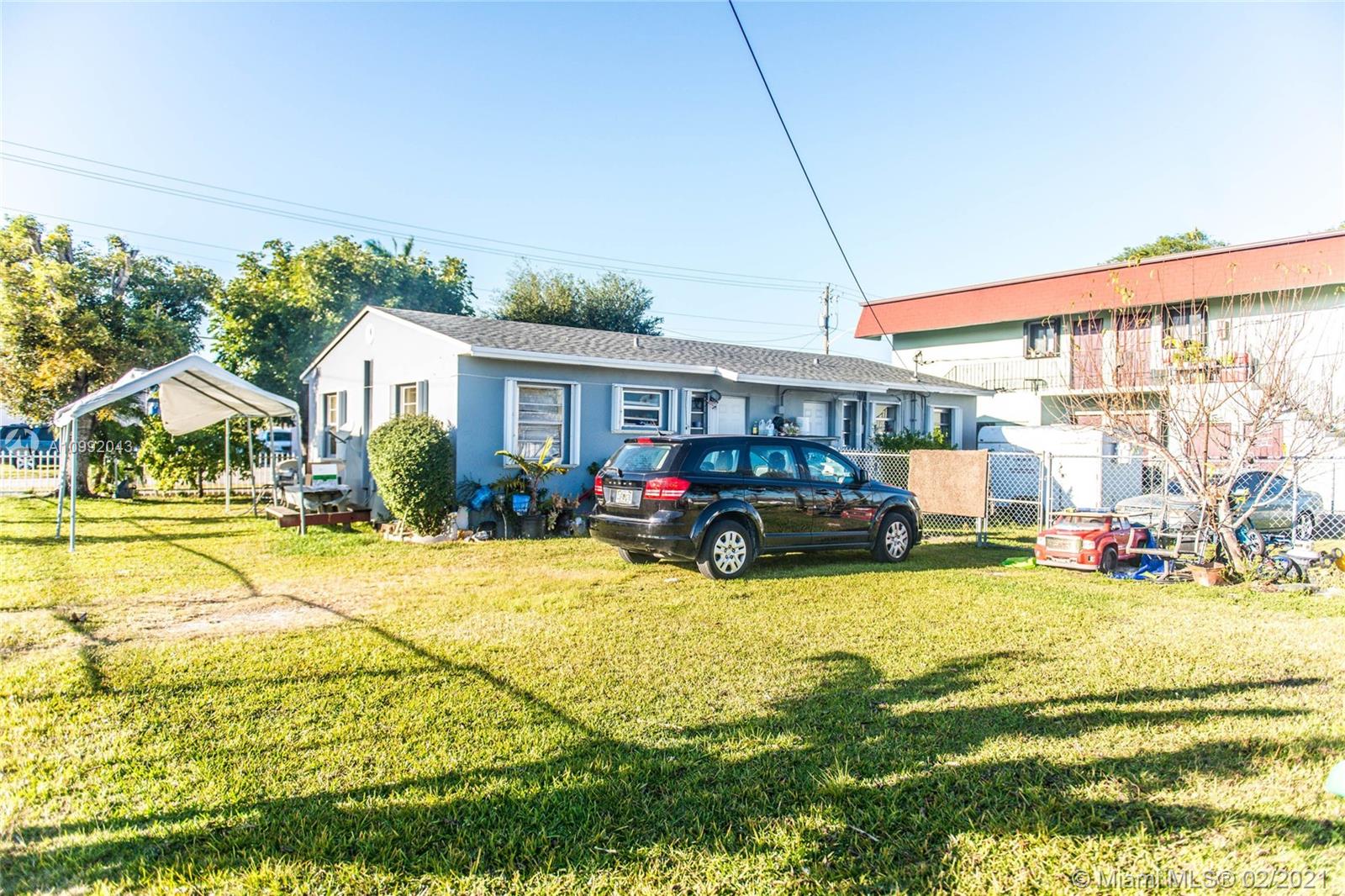 105 Northeast 2nd Road Homestead, FL 33030 - Photo 20 of 26 a view of swimming pool with lawn chairs and potted plants