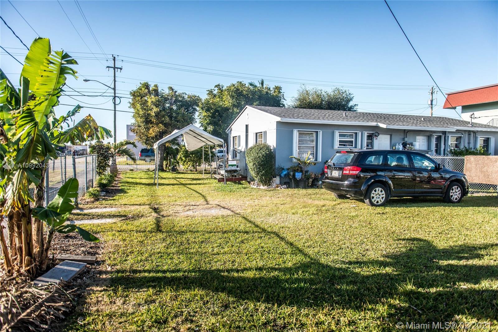 105 Northeast 2nd Road Homestead, FL 33030 - Photo 21 of 26 a house view with swimming pool and wooden fence