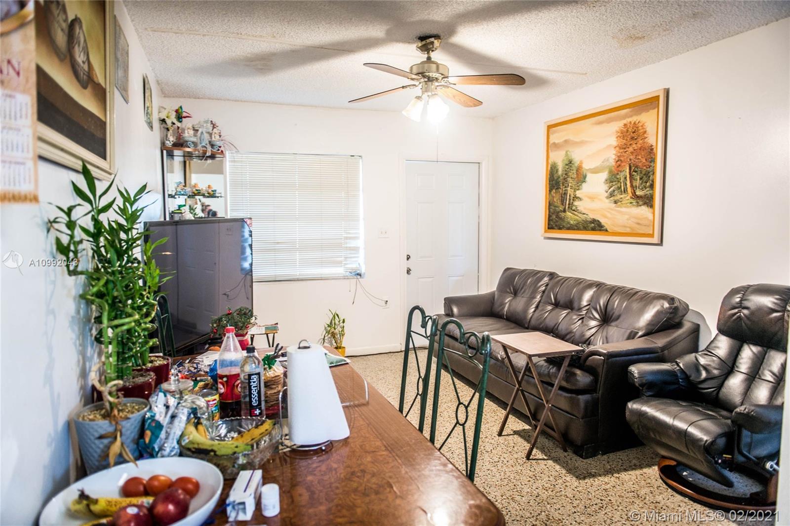 105 Northeast 2nd Road Homestead, FL 33030 - Photo 6 of 26 a living room with furniture and flowers