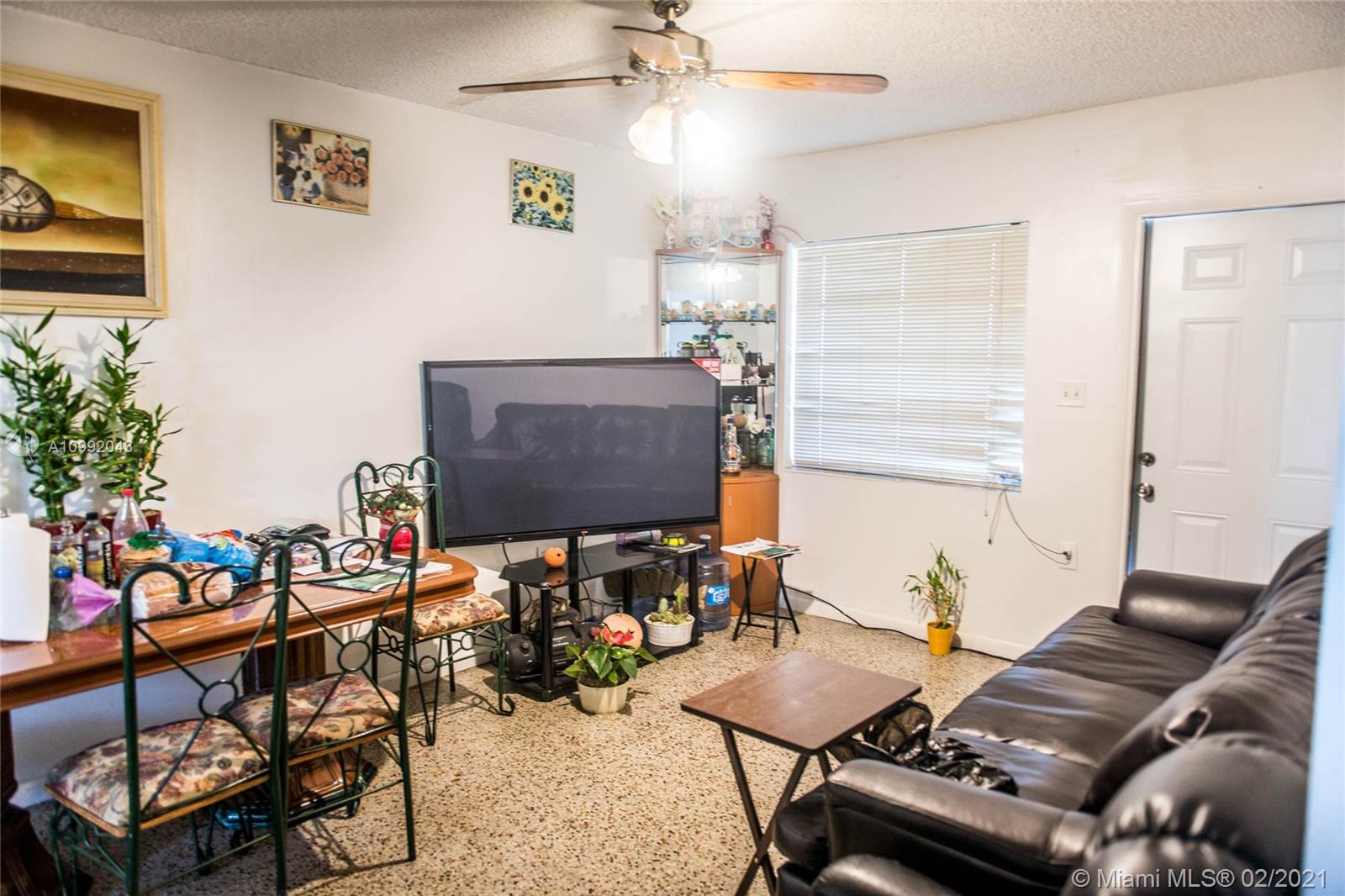 105 Northeast 2nd Road Homestead, FL 33030 - Photo 9 of 26 a living room with furniture a window and a flat screen tv