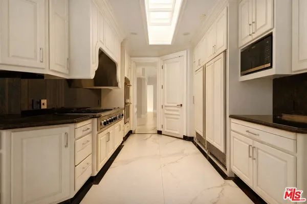 a spacious bedroom with a large bed and a large window