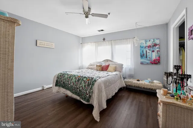 a bedroom with a bed table and a window