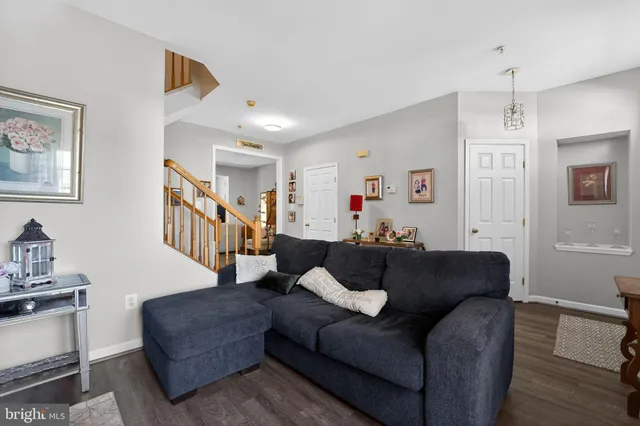 a living room with furniture and a ceiling fan