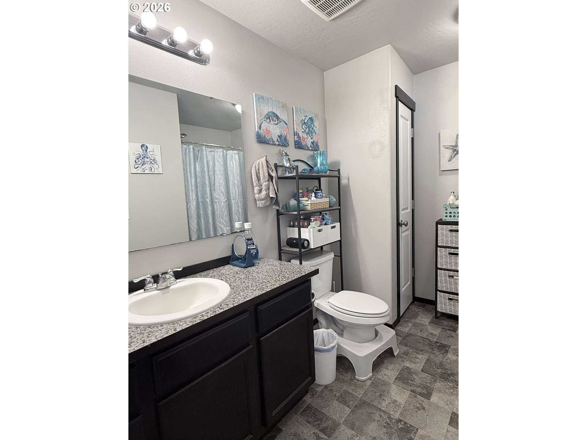 472 Cardinal Place Umatilla, OR 97882 - Photo 10 of 28 a bathroom with a granite countertop toilet sink and mirror
