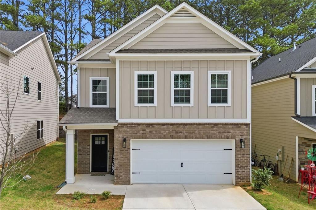 241 Bethany Manor Court Ball Ground, GA 30107 - Photo 1 of 36 a front view of a house with a garden