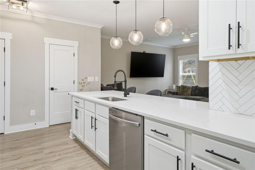 241 Bethany Manor Court Ball Ground, GA 30107 - Photo 11 of 36 a kitchen with a sink and a large window