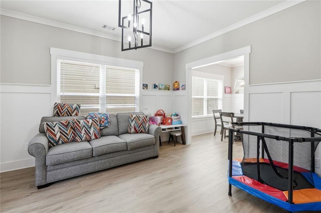 241 Bethany Manor Court Ball Ground, GA 30107 - Photo 14 of 36 a living room with furniture and a window