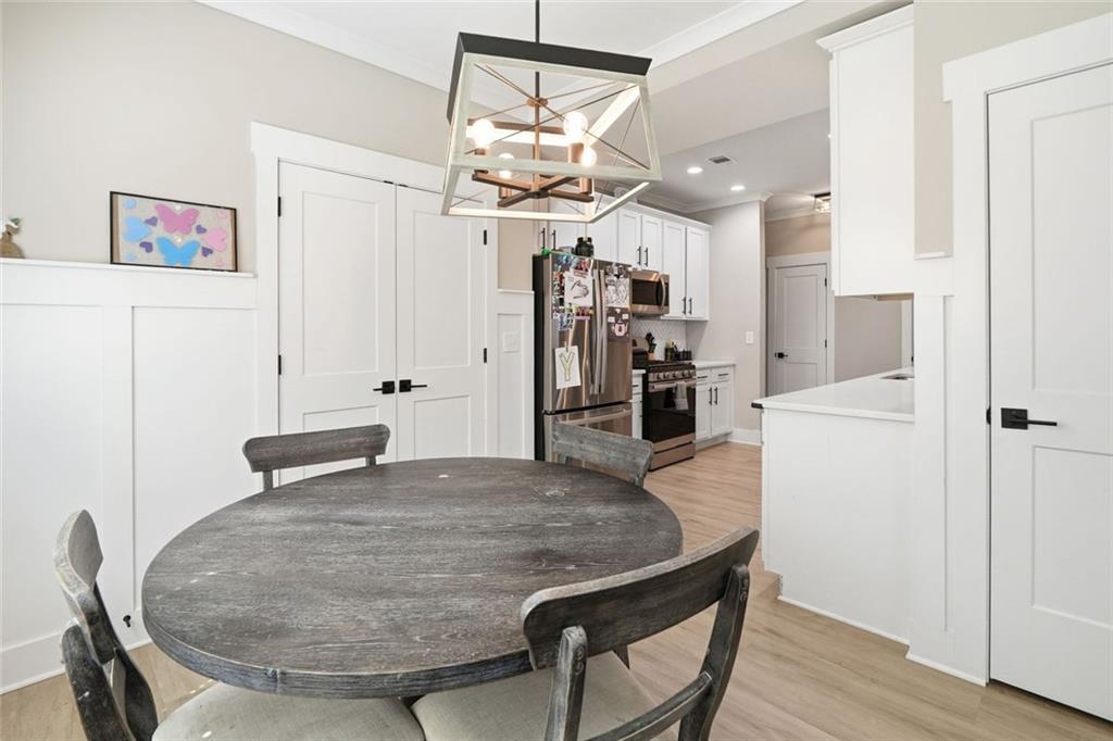 241 Bethany Manor Court Ball Ground, GA 30107 - Photo 16 of 36 a kitchen with stainless steel appliances kitchen island a refrigerator and microwave