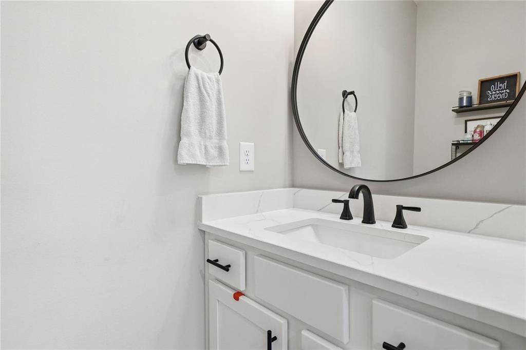 241 Bethany Manor Court Ball Ground, GA 30107 - Photo 18 of 36 a bathroom with a sink and a mirror