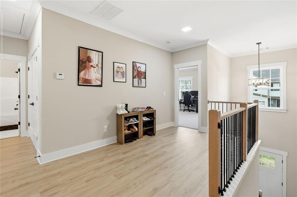 241 Bethany Manor Court Ball Ground, GA 30107 - Photo 19 of 36 a view of a hallway with wooden floor and furniture