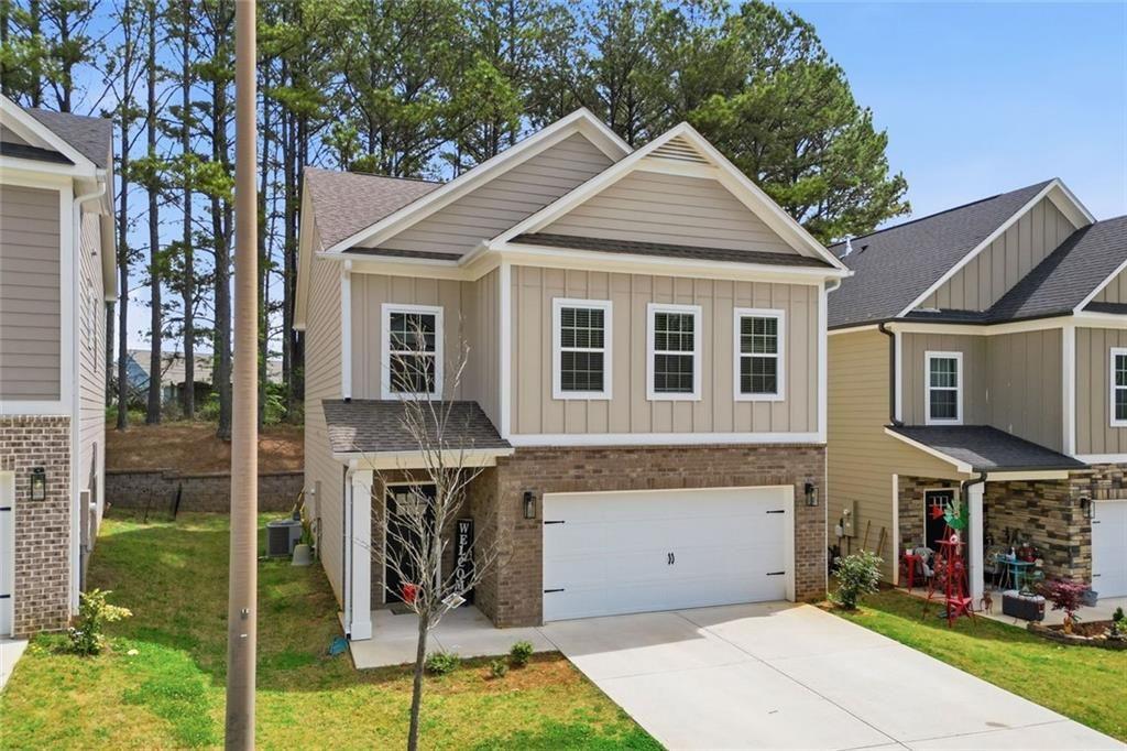 241 Bethany Manor Court Ball Ground, GA 30107 - Photo 2 of 36 a view of a house with garden