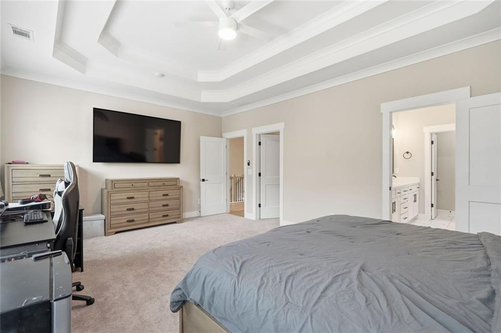 241 Bethany Manor Court Ball Ground, GA 30107 - Photo 23 of 36 a bedroom with a bed and a flat screen tv