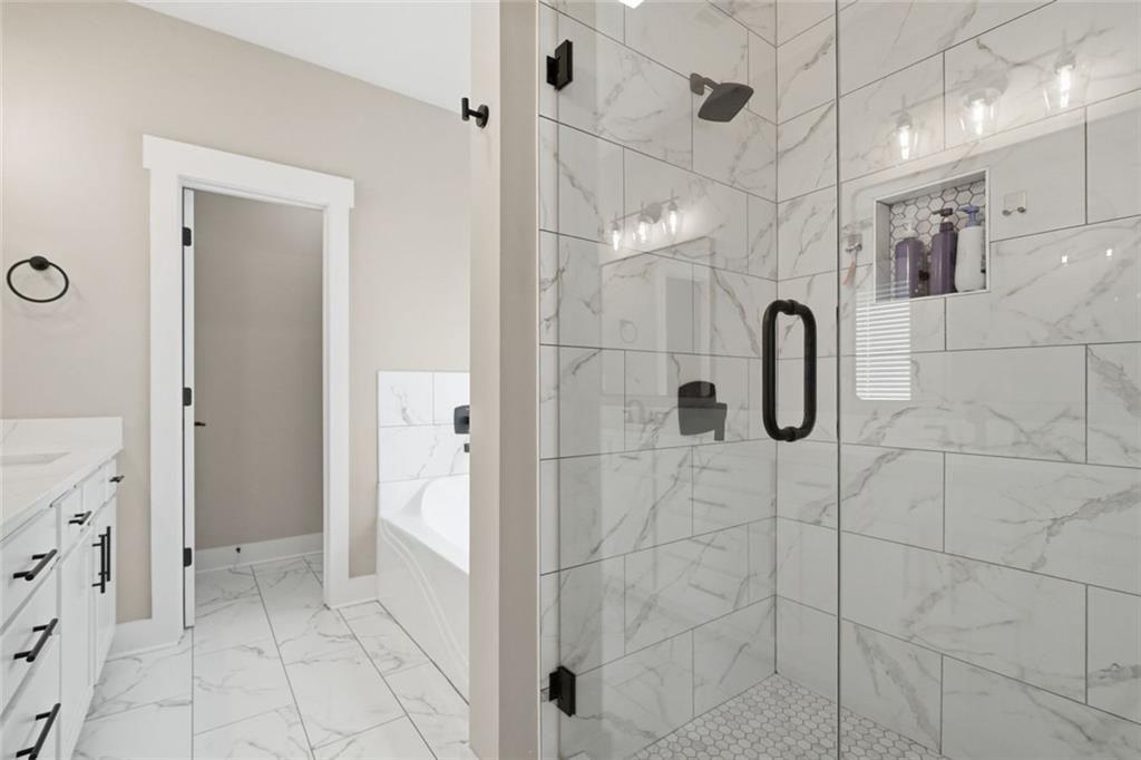 241 Bethany Manor Court Ball Ground, GA 30107 - Photo 24 of 36 a bathroom with a shower
