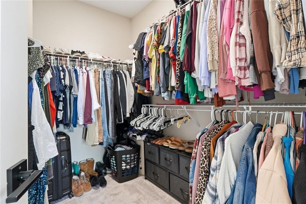 241 Bethany Manor Court Ball Ground, GA 30107 - Photo 27 of 36 a view of walk in closet with clothes and shoes