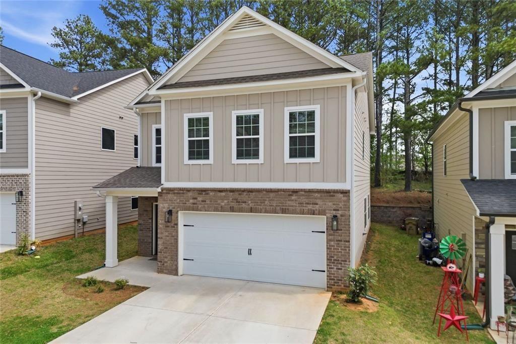 241 Bethany Manor Court Ball Ground, GA 30107 - Photo 3 of 36 a front view of a house with a yard