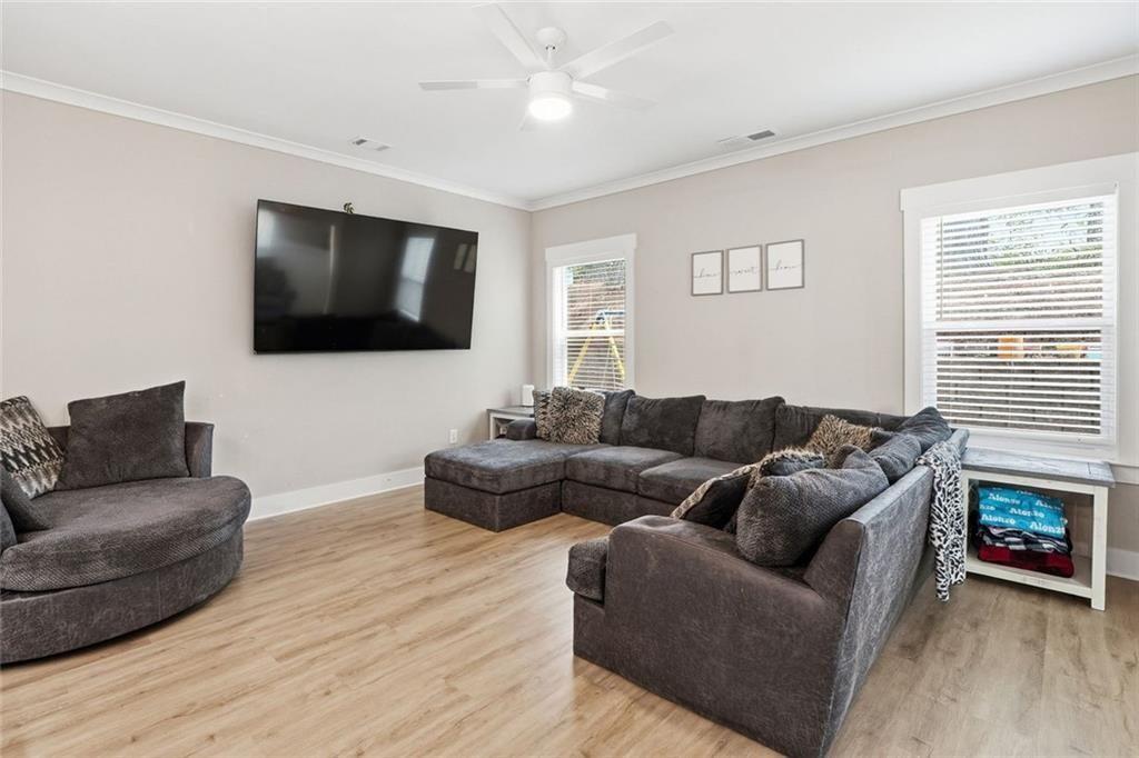 241 Bethany Manor Court Ball Ground, GA 30107 - Photo 34 of 36 a living room with furniture and a flat screen tv