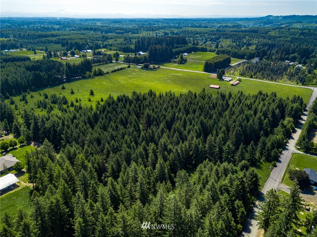 536 Brown Road East Chehalis, WA 98532 - Photo 35 of 38 a view of a lush green area with lawn chairs and wooden fence