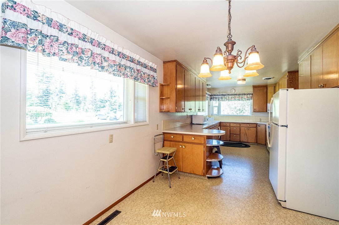 536 Brown Road East Chehalis, WA 98532 - Photo 10 of 38 a view of a dining room with furniture a chandelier and a window