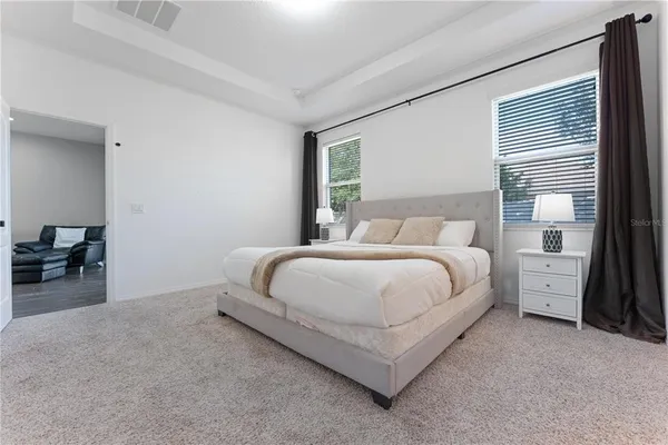 a bedroom with a bed and a night stand