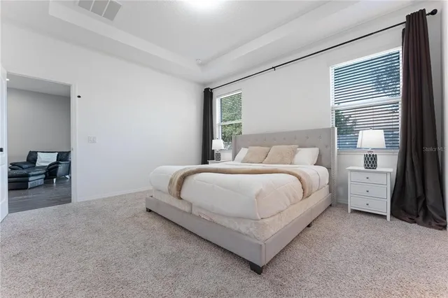 a bedroom with a bed and a night stand