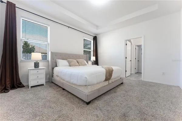 a work room with furniture a rug and a window